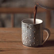 Load image into Gallery viewer, Hands pouring creamy Harth hot chocolate into ceramic mug, steam rising - luxury vegan hot chocolate
