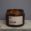 Load image into Gallery viewer, Solitude Scent. Winter Warmer. Fresh and spicy. Features nutmeg, patchouli and ginger notes. Soy wax . Our candles are all hand poured with natural plant based wax. Hand poured in the UK and poured in a brown amber glass by our female owned team. Long lasting candles that fully scent a room. Our candles are complete with a gold alliminium lid and then packaged in a beautiful botanical box, which features candle safety instructions in a cottage core theme. They are long lasting candles, rated excellent