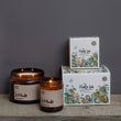 Load image into Gallery viewer, Solitude Scent. Winter Warmer. Fresh and spicy. Features nutmeg, patchouli and ginger notes. Soy wax . Our candles are all hand poured with natural plant based wax. Hand poured in the UK and poured in a brown amber glass by our female owned team. Long lasting candles that fully scent a room. Our candles are complete with a gold alliminium lid and then packaged in a beautiful botanical box, which features candle safety instructions in a cottage core theme. They are long lasting candles, rated excellent