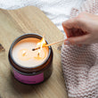 Load image into Gallery viewer, Midnight Cherry Natural Candle. Black Cherry, Amber + Frankincense: Natural Wax Candle. Our candles are all hand poured with natural plant based wax. Hand poured in the UK and poured in a brown amber glass by our female owned team. Long lasting candles that fully scent a room. Our candles are complete with a gold alliminium lid and then packaged in a beautiful botanical box, which features candle safety instructions in a cottage core theme. They are long lasting candles, rated excellent on Trust Pilot