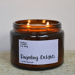Load image into Gallery viewer, Darjeeling Delights Tea Rose Fragrance. Very romantic, featuring dried tea leaves, dusky tea rose and lemon. Fresh and rose based. Best selling scent, ideal for spring, summer. Our candles are all hand poured with natural plant based wax. Hand poured in the UK and poured in a brown amber glass by our female owned team. Long lasting candles that fully scent a room.