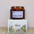 Load image into Gallery viewer, Darjeeling Delights Tea Rose Fragrance. Very romantic, featuring dried tea leaves, dusky tea rose and lemon. Fresh and rose based. Best selling scent, ideal for spring, summer. Our candles are all hand poured with natural plant based wax. Hand poured in the UK and poured in a brown amber glass by our female owned team. Long lasting candles that fully scent a room. Our candles are complete with a gold alliminium lid and then packaged in a beautiful botanical box, which features candle safety instructions