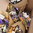 Load image into Gallery viewer, Sustainable dried wildflower bouquet featuring lavender, cornflowers, bunny tails. orange strawflowers, yellow yarrow, and preserved roses on a white surface. Plastic-free, long-lasting arrangement with rustic wheat stems and a natural tag. Perfect eco-friendly home décor from our forever-lasting collection. Birthday UK. Housewarming present when you don't know what to buy. Lavender & Peach flower bunch bouquets. Flowers for birthdays. Long lasting flowers. Dried flower bouquets