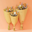 Load image into Gallery viewer, Sustainable dried wildflower bouquet featuring lavender, cornflowers, bunny tails. orange strawflowers, yellow yarrow, and preserved roses on a white surface. Plastic-free, long-lasting arrangement with rustic wheat stems and a natural tag. Perfect eco-friendly home décor from our forever-lasting collection. Birthday UK. Housewarming present when you don't know what to buy. Lavender & Peach flower bunch bouquets. Flowers for birthdays. Long lasting flowers. Dried flower bouquets