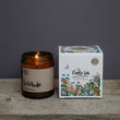 Load image into Gallery viewer, Solitude Scent. Winter Warmer. Fresh and spicy. Features nutmeg, patchouli and ginger notes. Soy wax . Our candles are all hand poured with natural plant based wax. Hand poured in the UK and poured in a brown amber glass by our female owned team. Long lasting candles that fully scent a room. Our candles are complete with a gold alliminium lid and then packaged in a beautiful botanical box, which features candle safety instructions in a cottage core theme. They are long lasting candles, rated excellent