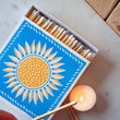 Load image into Gallery viewer, These eye catching sunshine Letterpress match boxes are the perfect accompaniment to your candle. Beautifully designed via vintage Victorian Letterpress techniques, resulting tactile, hand crafted keepsakes. Great candle accessory or a small token present. Made by a small business. Blue and yellow and white match box.