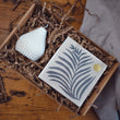 Load image into Gallery viewer, The Light Lovers candle box featuring an unscented soy wax natural-wax pillar candle and a box of letterpress matches in a sustainanly made gift box.