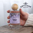 Load image into Gallery viewer, Hand holding a bottle of 'Darjeeling Delights' room perfume with a wooden cap, labeled Home Fragrance 'Gift of the Year Shortlisted'.
