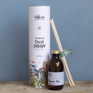 Close-up of Alpine Air Reed Diffuser with Natural Rattan Reeds. Perfect fresh scent.  Hand poured soy derived diffuser made of natural ingredients. Perfect for summer time scenting. Room filling diffuser with 6 natural rattan reeds and comes in a beautoful presentation box, which features wild flowers and animals on it. Cottage core in its sttyle, it is perfect for nature lovers. 
