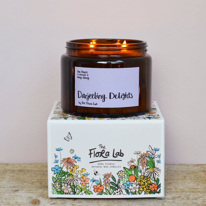 Darjeeling Delights Tea Rose Fragrance. Very romantic, featuring dried tea leaves, dusky tea rose and lemon. Fresh and rose based. Best selling scent, ideal for spring, summer. Our candles are all hand poured with natural plant based wax. Hand poured in the UK and poured in a brown amber glass by our female owned team. Long lasting candles that fully scent a room. Our candles are complete with a gold alliminium lid and then packaged in a beautiful botanical box, which features candle safety instructions