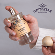 Load image into Gallery viewer, Hand holding a room perfume bottle with decorative label and wooden cap, against a neutral background.
