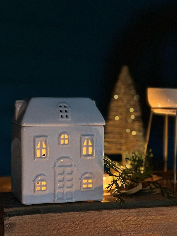 Winter House Ceramic Wax Melt Burner. Elegant ceramic wax melt burner paired with our handcrafted botanical wax melts and tealights. Stylish home fragrance solution designed for long-lasting and strong scent release. Premium quality ceramic burner with stars cut out to let the light shine through. Best paired with plant based natural wax tealights and soy wax melts from The Flora Lab 