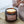 Load image into Gallery viewer, Velvety chocolately woods are the notes that make this winter warmer candle so popular. Unisex, appealing to both men and women, this scent is perfect for Autumn. It is great for the bedroom. Features warming notes such as chocolate, vetiver, warm spices, and nutmeg.  Woodland Glow Double Wick Long Lasting Candle being lit by a luxury match 
