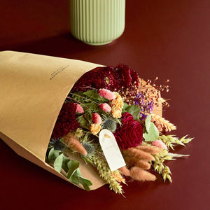 Burgundy Medium Bouquet of dried flowers close up showing a rose, bunny nails and other seasonal foliage. 