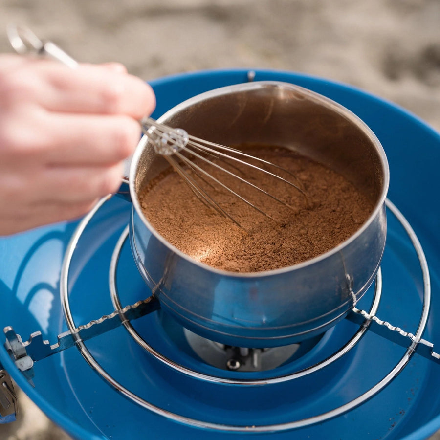 Harth cinnamon hot chocolate being whisked in saucepan - Swiss style spiced preparation