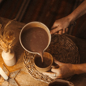 Steaming saucepan of Harth cinnamon hot chocolate with oat milk - warming spiced winter treat