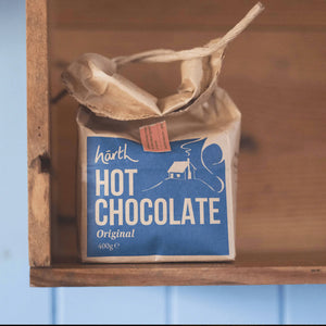 Close-up of Harth hot chocolate tin showing plastic-free sustainable packaging and organic ingredients