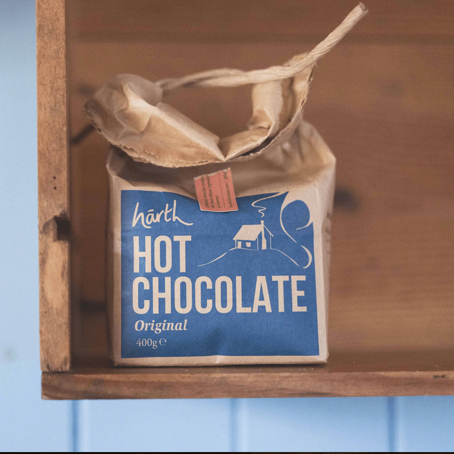Close-up of Harth hot chocolate tin showing plastic-free sustainable packaging and organic ingredients