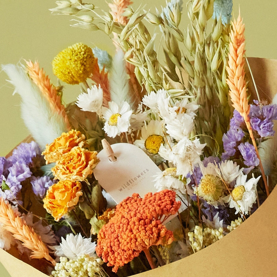 Dried Flowers - Field Bouquet - Pastel Delight close up of he large bouquet. All sustainably grown and dried. This bouquet contains: Natural oats, natural wheat, pesca wheat, light blue phalaris, light blue lagurus, craspedia, trinity spray roses, green amaranthus, lavender statice, white rhodanthe, and frosted salmon achillea.