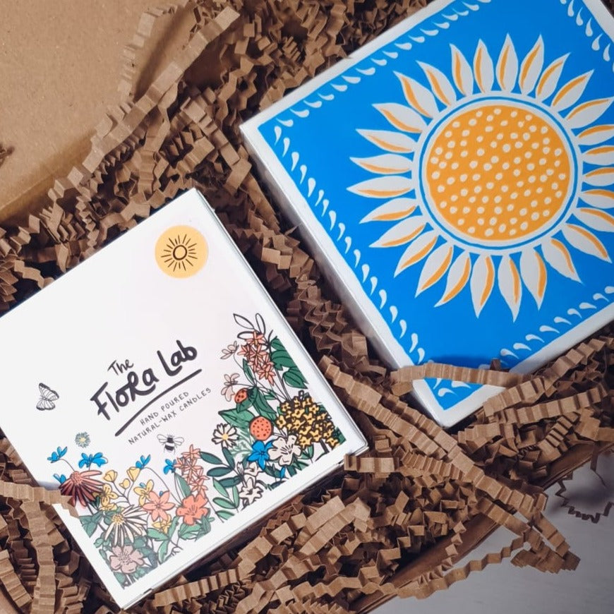 
Sicilian Sunbeam Double Wick Candle, luxury Letterpress sunshine match box in our ray of sunshine sustainable gift box. Our sustainably sourced gift boxes are made with sustainable materials, filled with sustainable scent and feature a hand tired cotton ribbon. Perfect for gifts, such as birthday presents, housewarming and sympathy gifts. Bespoke and customisable gift boxes UK. Beautiful botanical gift. 