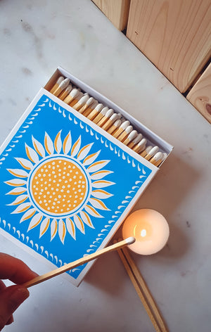 These eye catching sunshine Letterpress match boxes are the perfect accompaniment to your candle. Beautifully designed via vintage Victorian Letterpress techniques, resulting tactile, hand crafted keepsakes. Great candle accessory or a small token present. Made by a small business. Blue and yellow and white match box. 